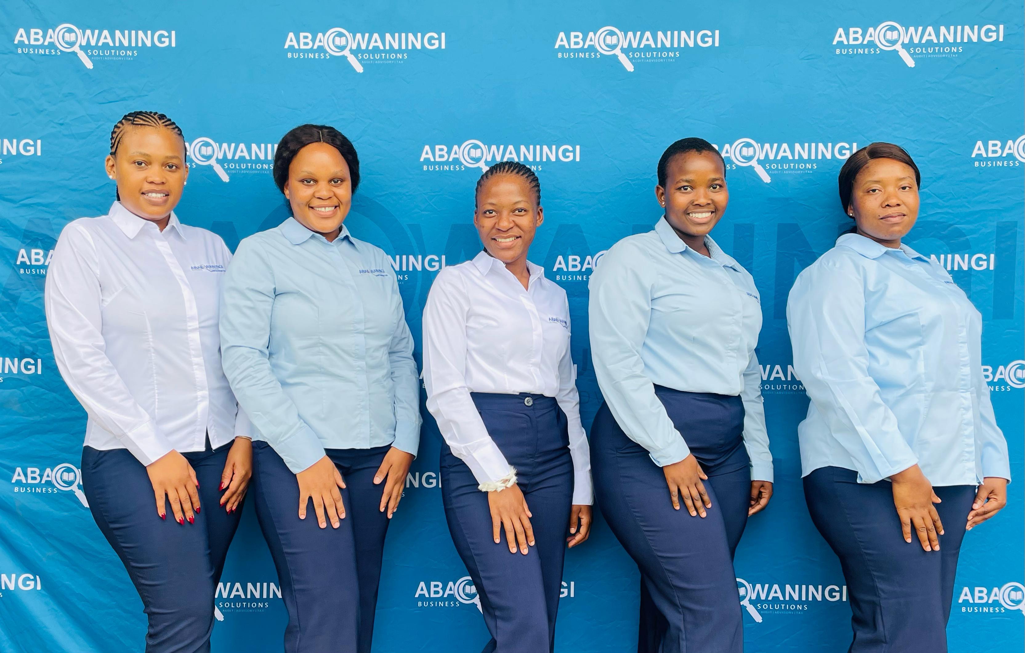 The Abacwaningi team in front of the branded wall